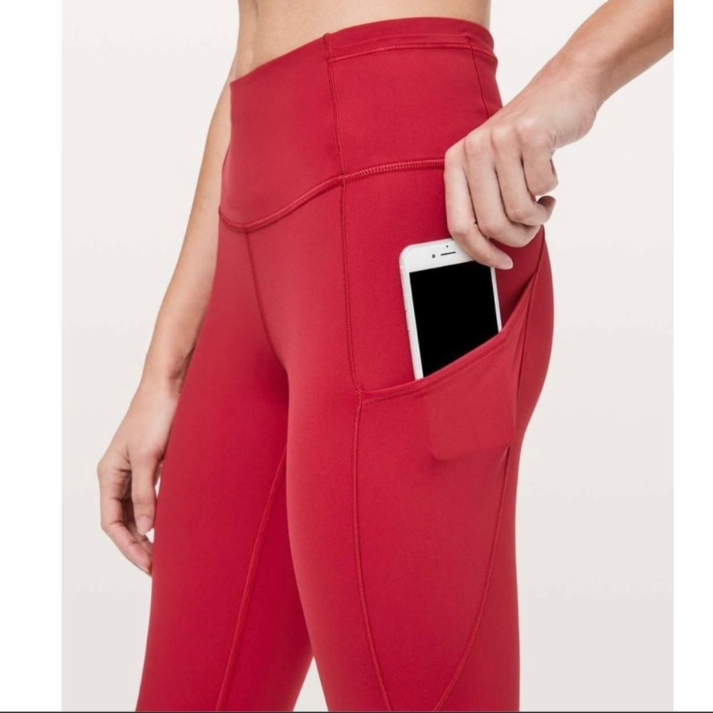 Fast and Free High Rise with pockets size 6 and 25” Inseam. Dark red in color.